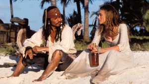 Jack Sparrow ed Elisabeth Swan condividono una spiaggia e una bottiglia di whiskey, in Pirati dei Caraibi La maledizione della prima luna